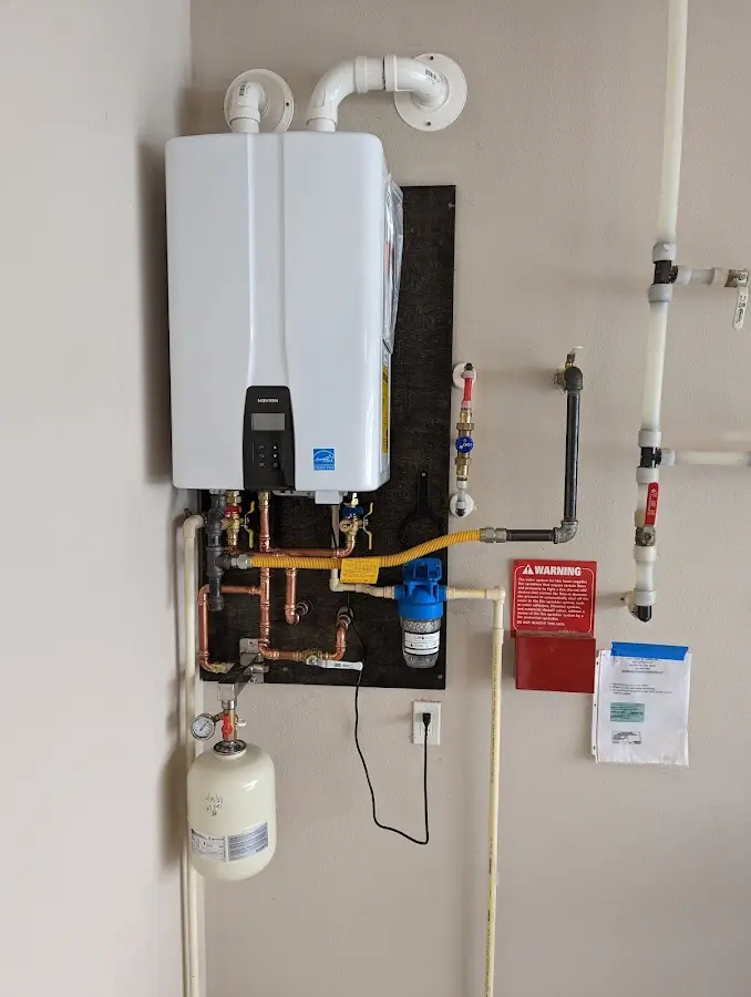 Professional plumber installing copper piping in a Lyndon home